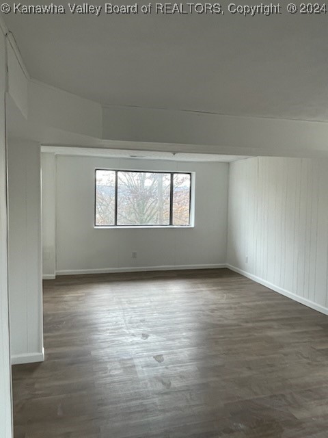 spare room featuring dark hardwood / wood-style flooring