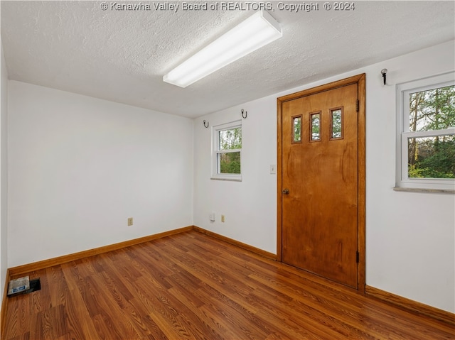 empty room featuring hardwood / wood-style floors and a textured ceiling