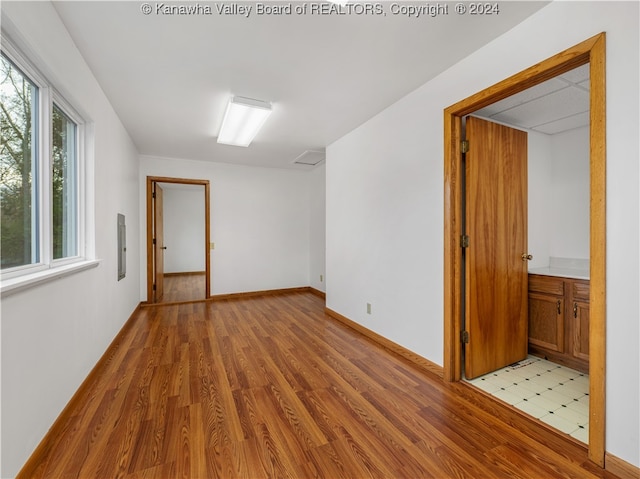 unfurnished room with light wood-type flooring and electric panel