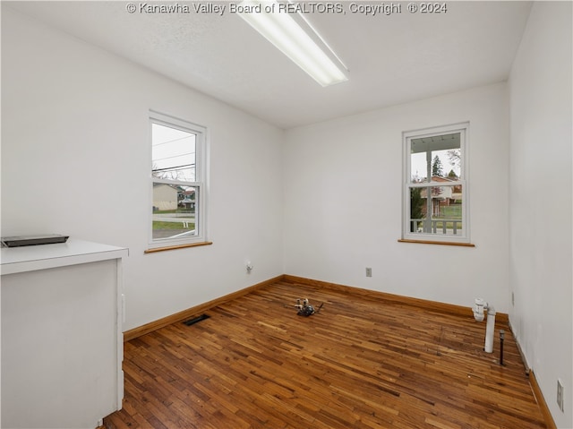 spare room with hardwood / wood-style flooring