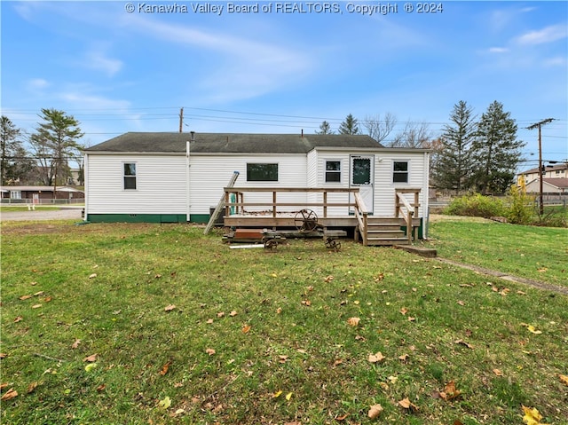 back of house with a lawn and a wooden deck