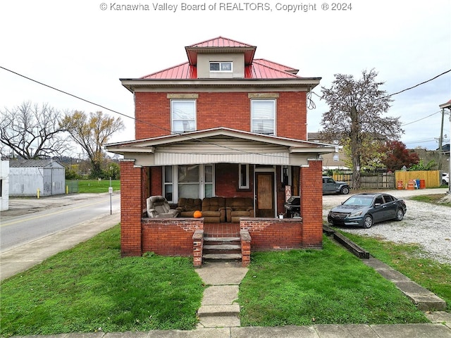 view of front of home featuring a porch and a front lawn