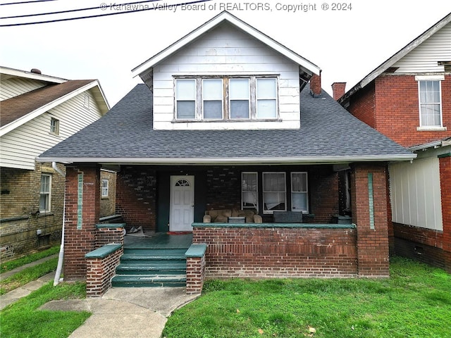 view of front of home with a front lawn and covered porch