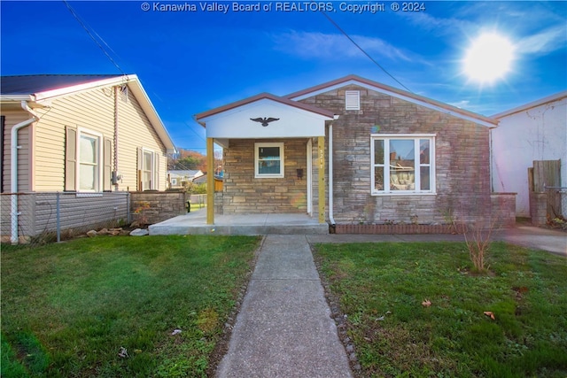 bungalow-style home with a porch and a front lawn