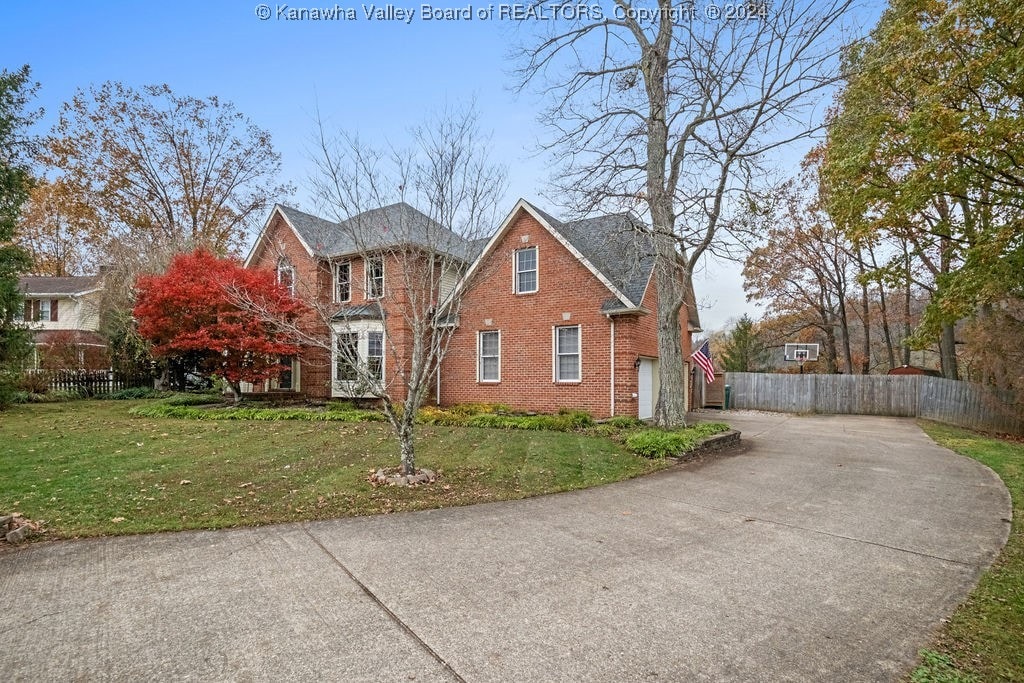 view of front of home with a front yard and a garage