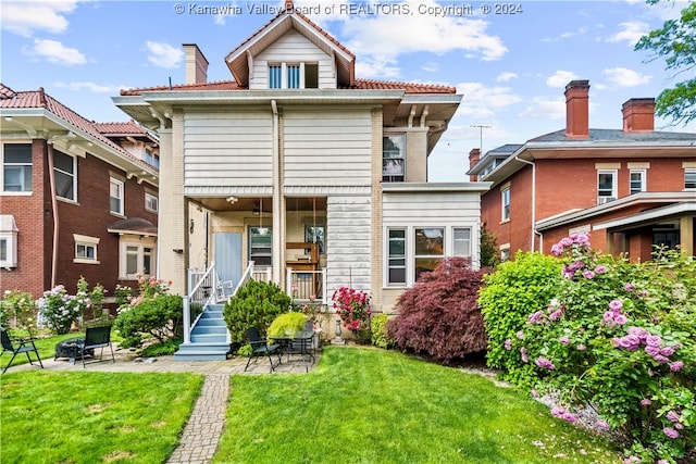 rear view of house with a yard