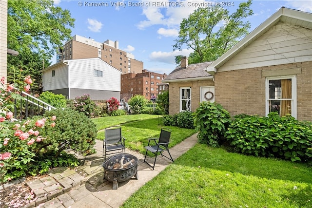 view of yard with a fire pit