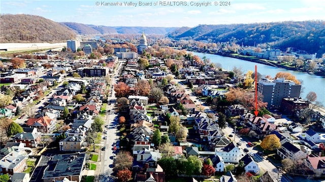 birds eye view of property featuring a water and mountain view