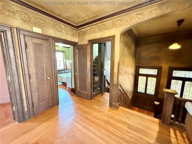 entrance foyer featuring crown molding, french doors, and light hardwood / wood-style floors