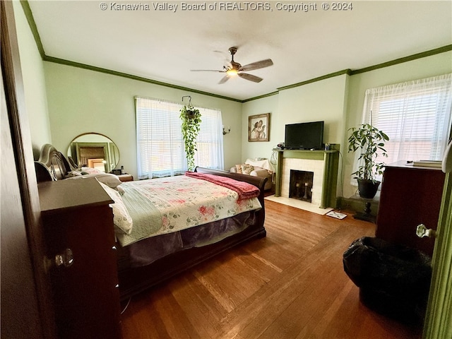 bedroom with ceiling fan, ornamental molding, and multiple windows