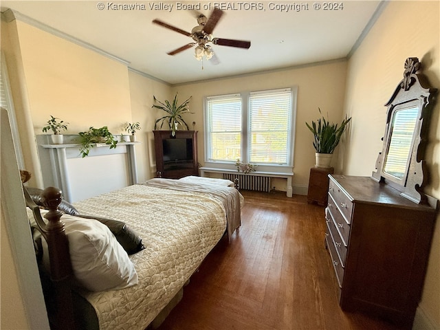 bedroom featuring multiple windows, ornamental molding, radiator, and dark wood-type flooring