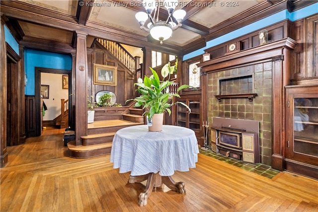 dining room with a chandelier, beamed ceiling, ornamental molding, and coffered ceiling