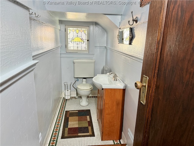 bathroom featuring tile patterned flooring, vanity, and toilet