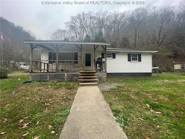 view of front of home with a porch and a front yard