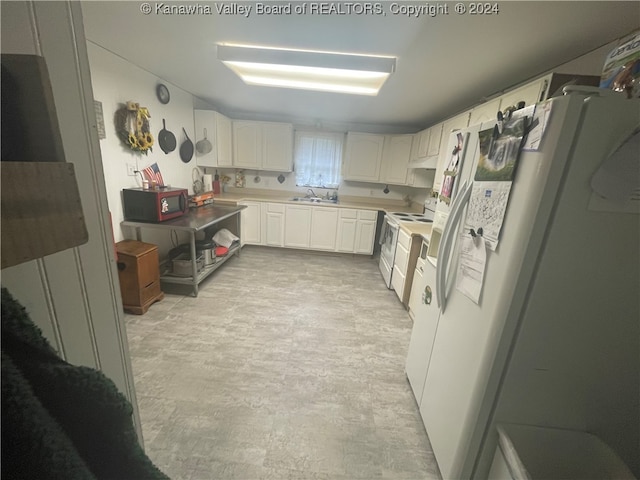 kitchen featuring white cabinetry, sink, and white appliances