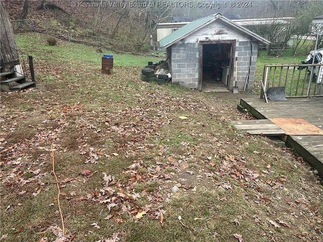 view of yard featuring a storage shed and a deck