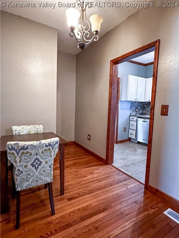 interior space with light hardwood / wood-style flooring and a chandelier