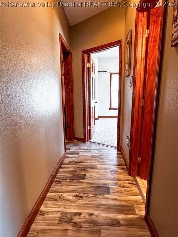 hall with light wood-type flooring