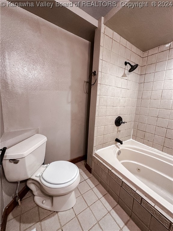 bathroom with toilet, tiled shower / bath combo, and tile patterned floors