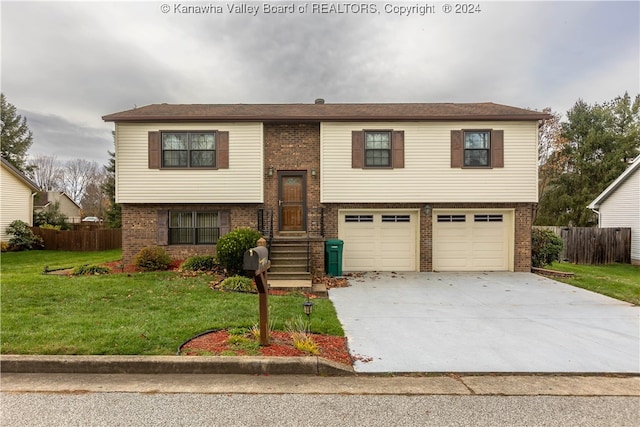 bi-level home with a garage and a front lawn