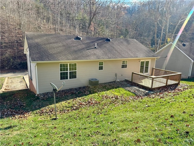 rear view of house featuring central AC, a yard, and a deck