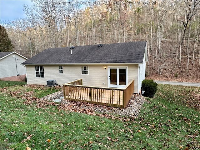 rear view of house featuring a lawn, a wooden deck, and central AC