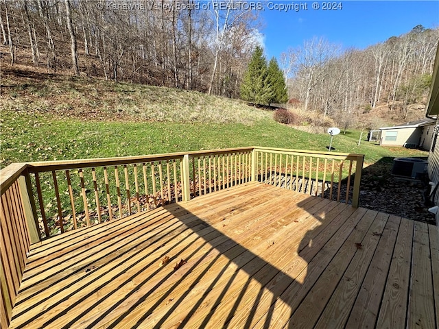 wooden terrace featuring a yard and central AC unit