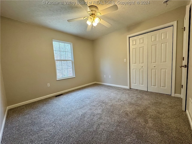 unfurnished bedroom with ceiling fan, a closet, carpet, and a textured ceiling