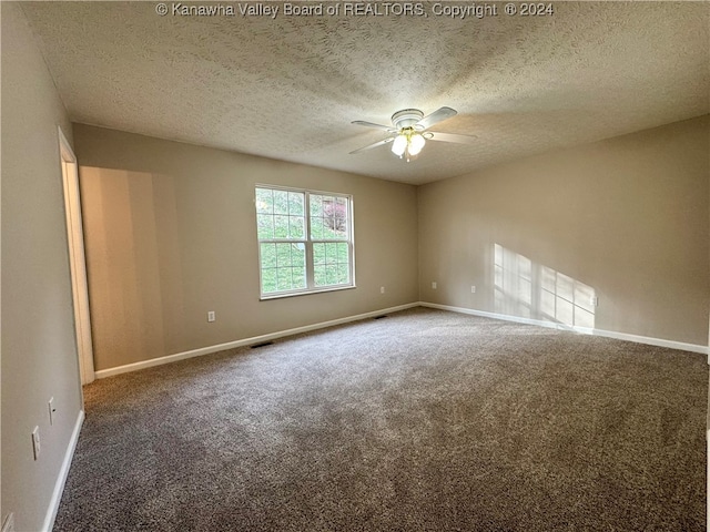 spare room featuring ceiling fan, carpet floors, and a textured ceiling