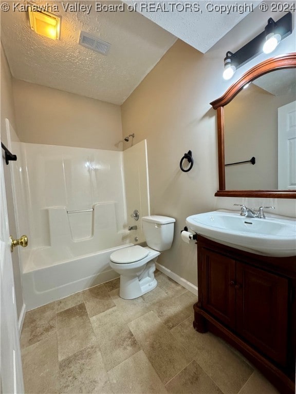 full bathroom featuring vanity, shower / bathtub combination, toilet, and a textured ceiling