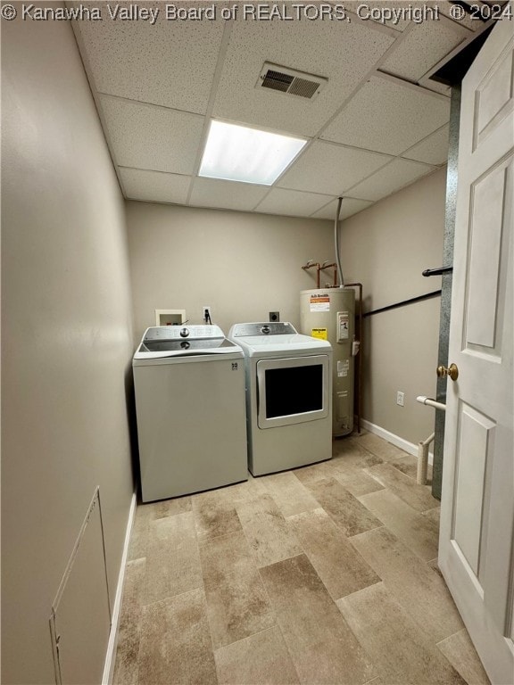 laundry room featuring washing machine and dryer and water heater