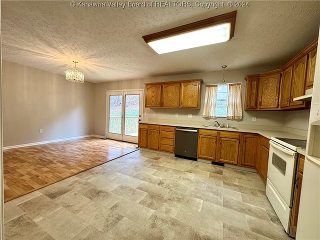 kitchen featuring electric range, pendant lighting, stainless steel dishwasher, and light wood-type flooring