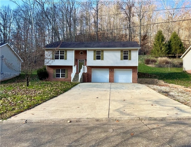 split foyer home featuring a front yard and a garage