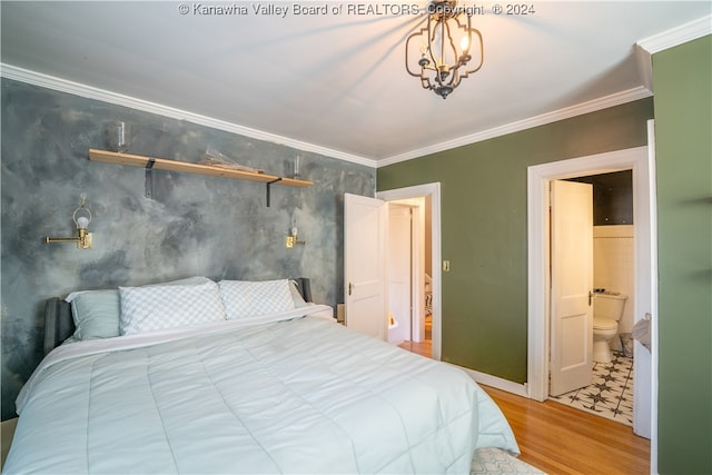 bedroom with wood-type flooring, ensuite bathroom, an inviting chandelier, and ornamental molding