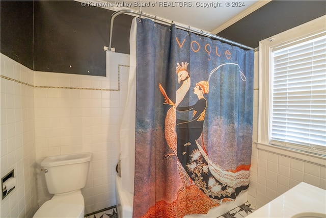 bathroom featuring ornamental molding, toilet, tile walls, and shower / bath combo with shower curtain