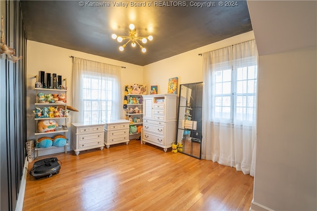 interior space with light hardwood / wood-style flooring and an inviting chandelier