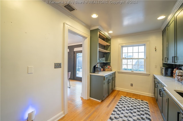 kitchen with light hardwood / wood-style floors and crown molding