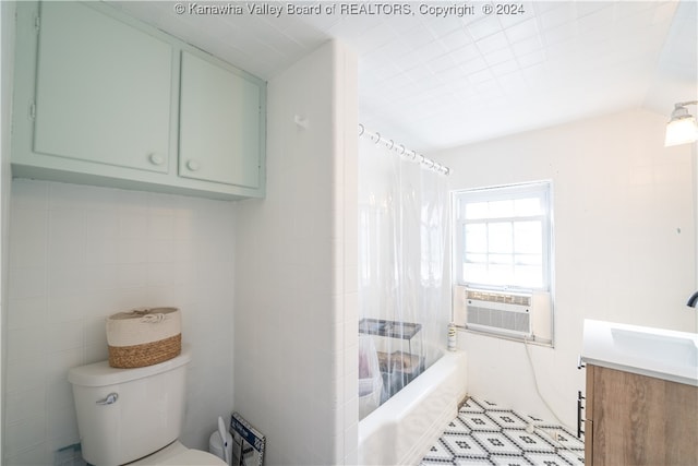 full bathroom featuring cooling unit, vaulted ceiling, toilet, vanity, and shower / tub combo