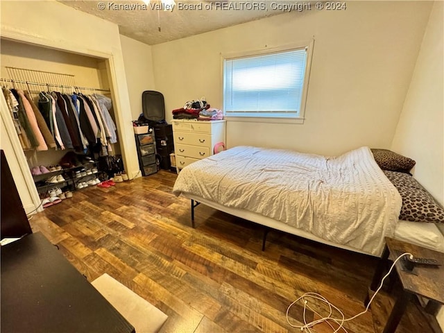 bedroom featuring dark hardwood / wood-style flooring and a closet