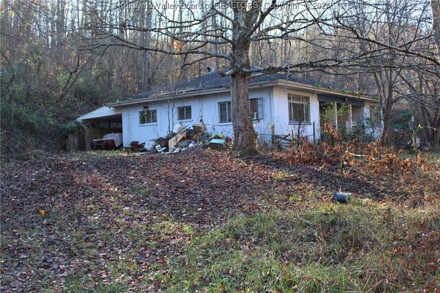 view of side of property with a carport