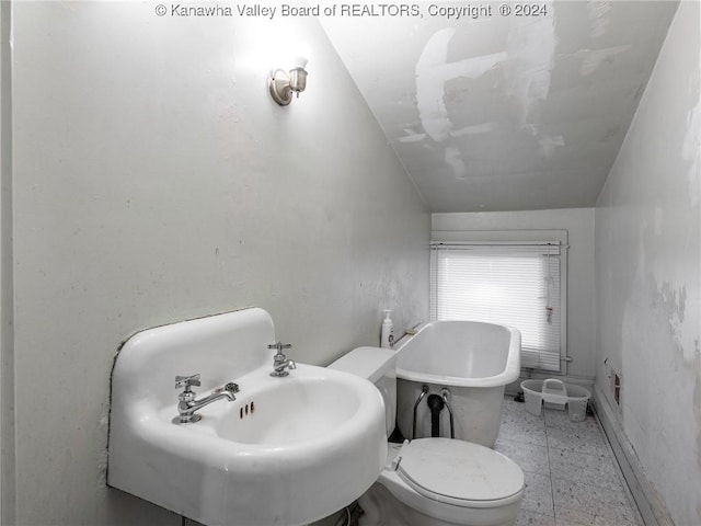 1515 Lee St E, Charleston, WV 25311 - bathroom featuring a bathtub, toilet, sink, and vaulted ceiling