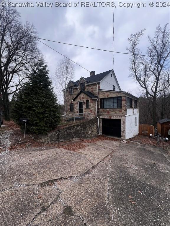 view of side of property with a garage