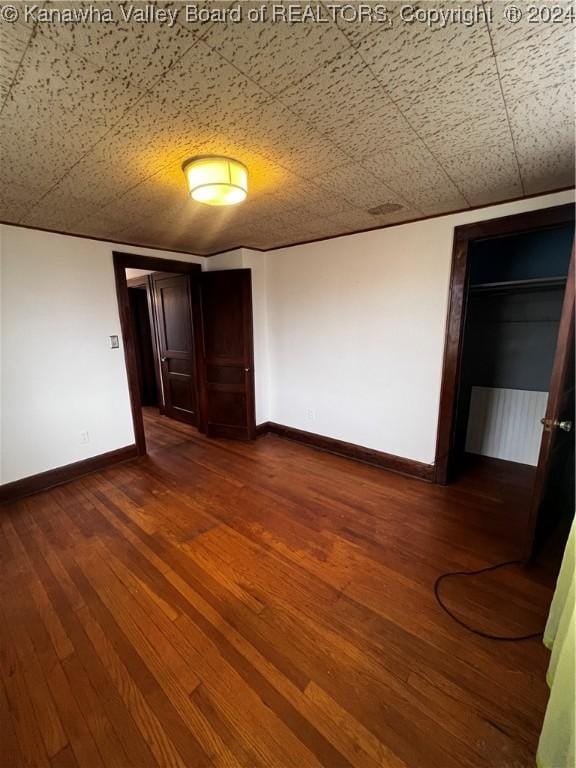 unfurnished room with wood-type flooring