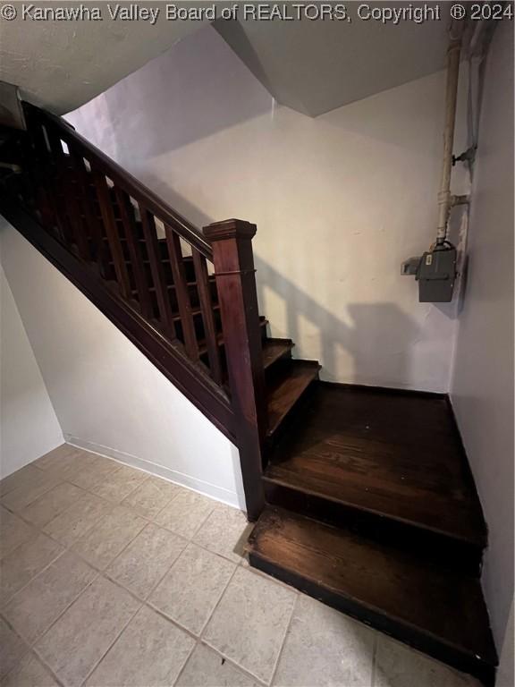 staircase featuring tile patterned floors