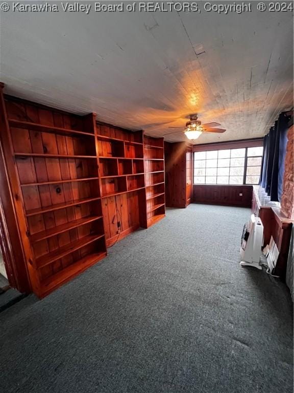 unfurnished living room featuring carpet and ceiling fan