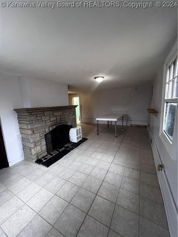 unfurnished living room featuring a fireplace