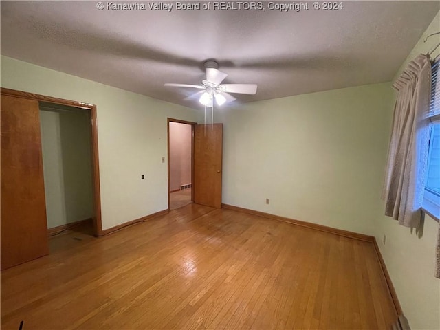 unfurnished bedroom featuring light hardwood / wood-style floors and ceiling fan