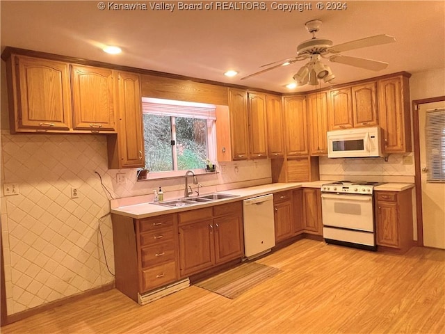 kitchen with white appliances, sink, light hardwood / wood-style flooring, ceiling fan, and decorative backsplash