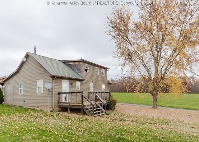 back of house with a wooden deck and a yard