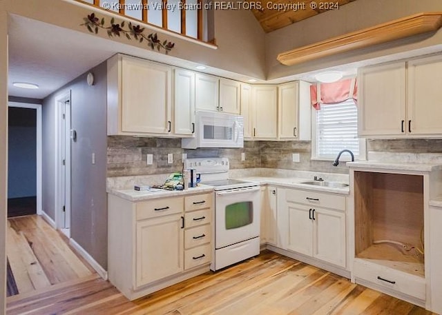 kitchen featuring backsplash, light hardwood / wood-style flooring, white appliances, and sink